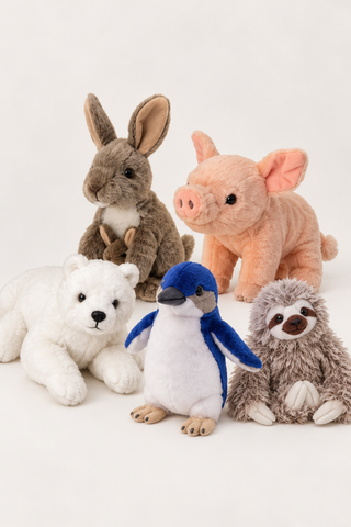 A group of five soft plush animal toys arranged together on a clean white studio background. The toys include a brown rabbit holding a small brown bunny, a peach pig, a white polar bear, a blue-and-white penguin, and a gray-brown sloth.