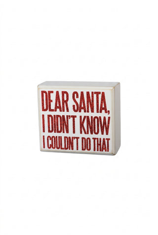 Decorative block with red text 'Dear Santa, I didn't know I couldn't do that' on a white background