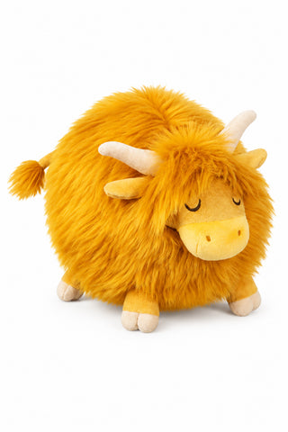 A fluffy yellow Highland cow plush toy with cream-colored horns and legs.