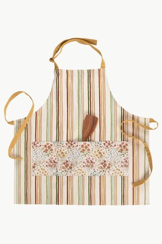 Striped apron with a floral pocket and wooden spatula on a white background