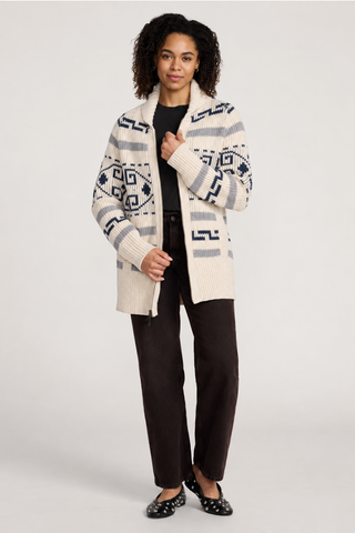 Woman wearing a pendleton geometric cardigan in a cream color with gray and blue accents.